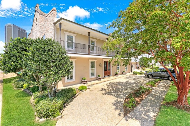 rear view of property with a balcony