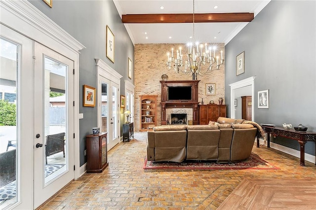 living room with french doors, a towering ceiling, beam ceiling, and a chandelier