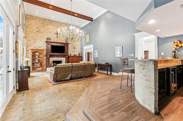 living room featuring a high ceiling, wine cooler, plenty of natural light, and a fireplace