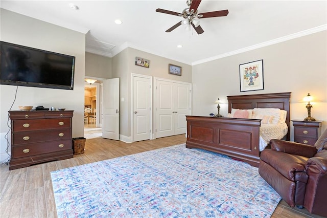 bedroom with ornamental molding, ceiling fan, and light hardwood / wood-style flooring