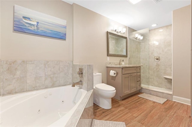 full bathroom with shower with separate bathtub, vanity, hardwood / wood-style floors, and toilet