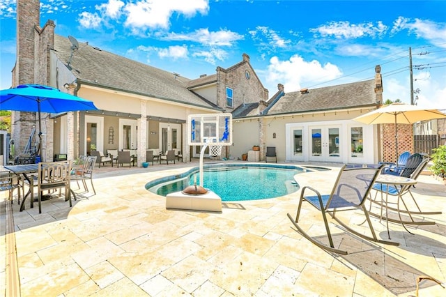 view of pool featuring french doors and a patio area