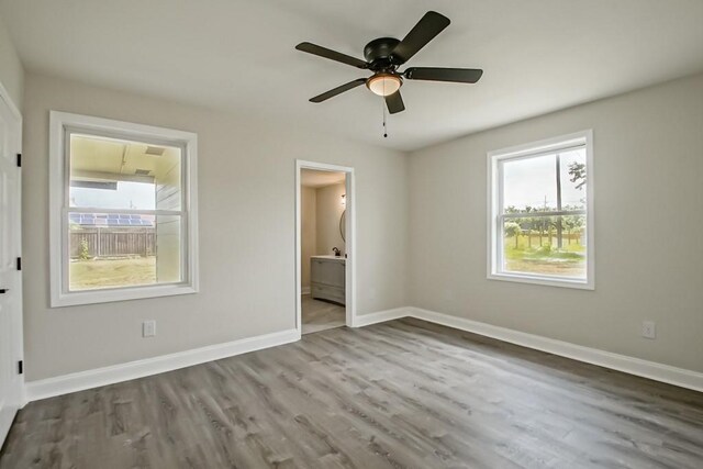 bedroom featuring connected bathroom, ceiling fan, and dark hardwood / wood-style floors