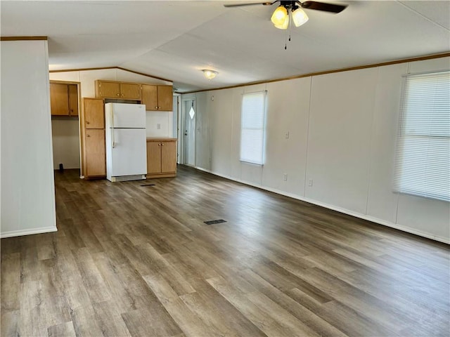 unfurnished living room featuring ceiling fan, wood-type flooring, and vaulted ceiling