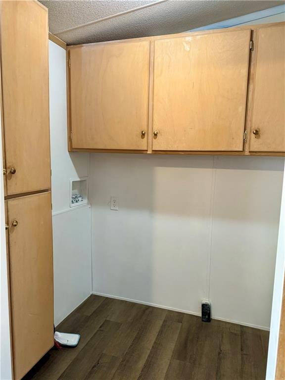 clothes washing area with washer hookup, dark hardwood / wood-style flooring, cabinets, and a textured ceiling