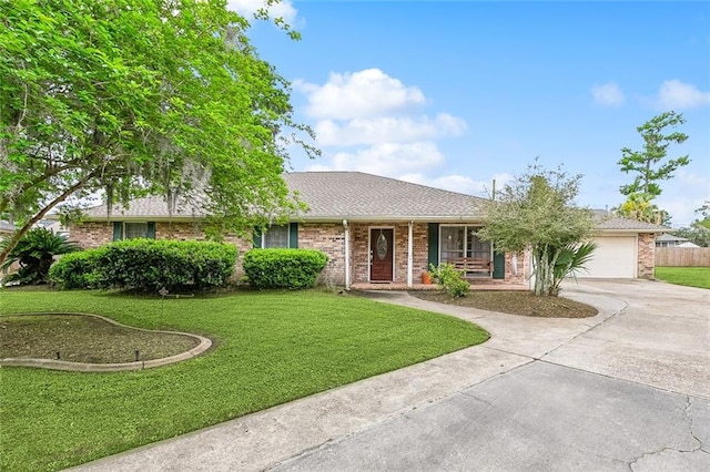 single story home with a porch, a garage, and a front lawn