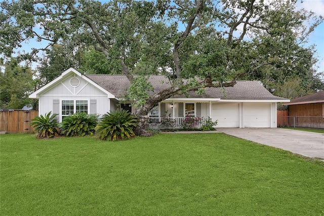 ranch-style home with covered porch, a garage, and a front yard