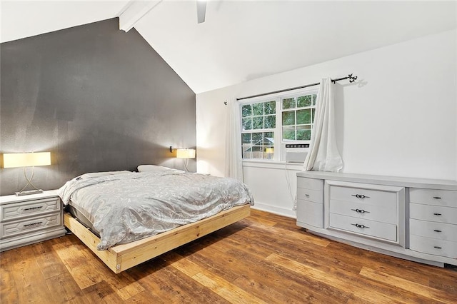 bedroom featuring ceiling fan, hardwood / wood-style floors, and vaulted ceiling with beams