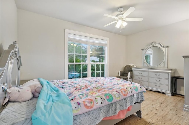 bedroom with light wood-type flooring and ceiling fan