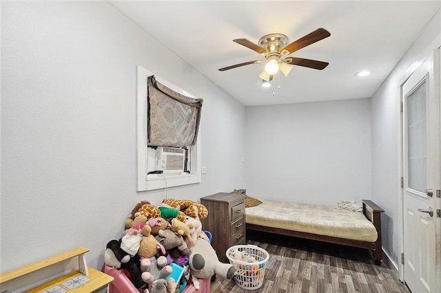 bedroom featuring ceiling fan, dark wood-type flooring, and cooling unit