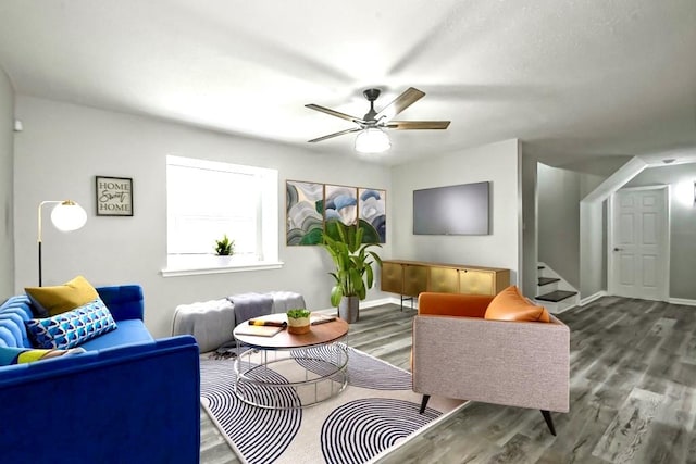 living room featuring ceiling fan and wood-type flooring