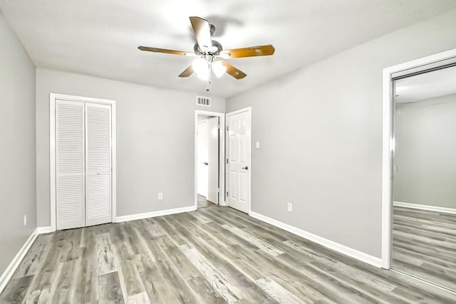 unfurnished bedroom with ceiling fan and hardwood / wood-style floors