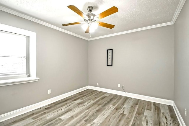 unfurnished room featuring a textured ceiling, ornamental molding, wood-type flooring, and ceiling fan