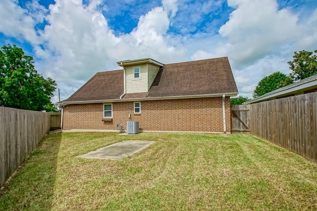 back of house featuring central AC and a lawn