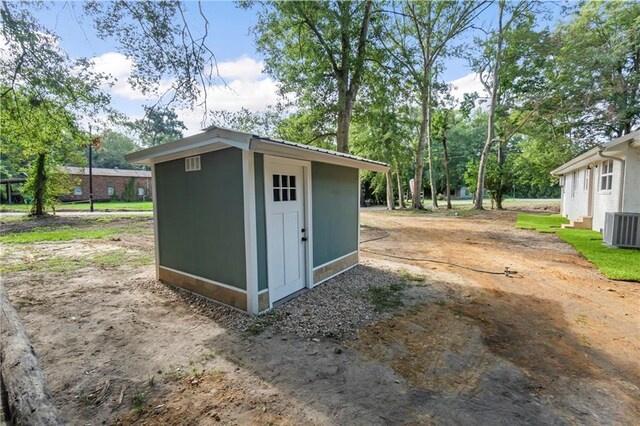 view of outbuilding featuring central air condition unit