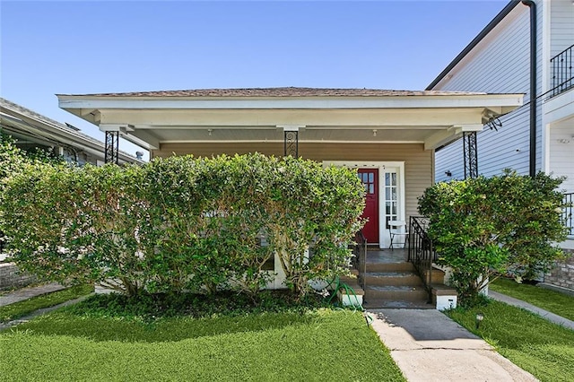 property entrance with a lawn