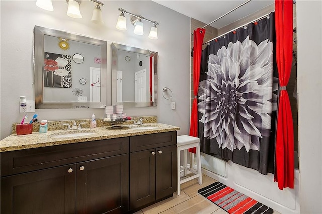 bathroom featuring dual vanity, shower / tub combo, and tile patterned flooring