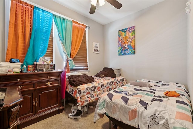 bedroom featuring ceiling fan and carpet