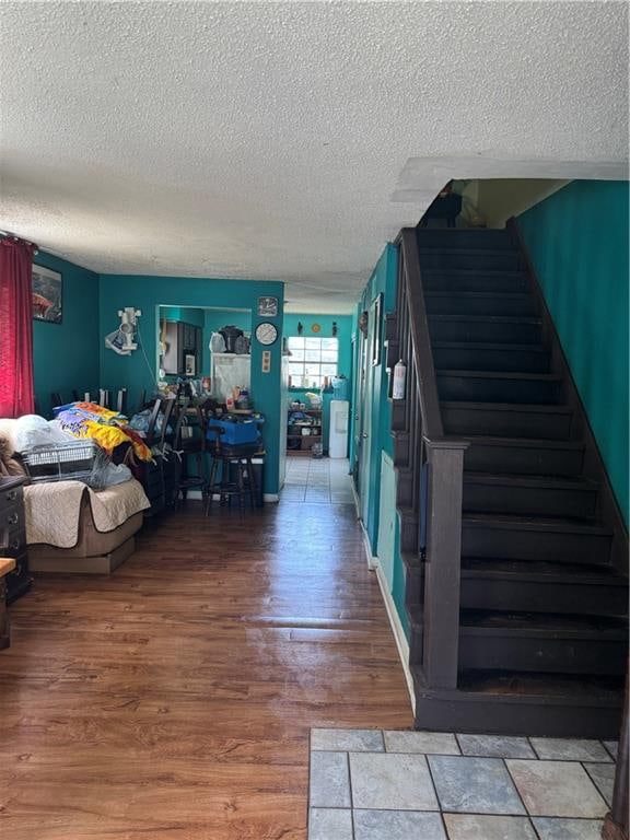 bedroom with wood-type flooring and a textured ceiling