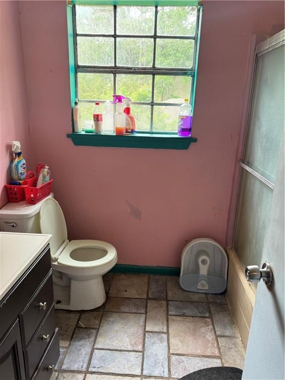 bathroom featuring tile patterned floors, toilet, and vanity