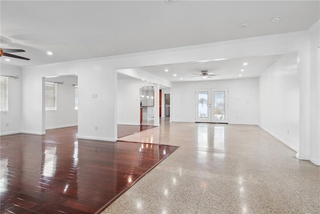 empty room with ceiling fan, french doors, and crown molding