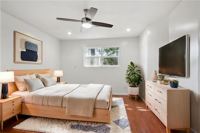 bedroom with ceiling fan and dark hardwood / wood-style floors