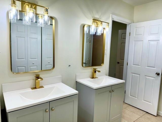 bathroom with double sink vanity and tile patterned flooring