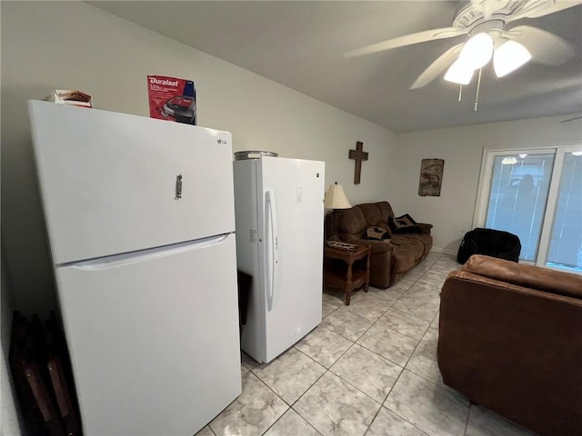 kitchen with light tile patterned flooring, ceiling fan, and white fridge