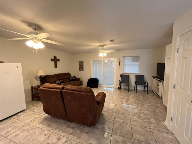 tiled living room with ceiling fan