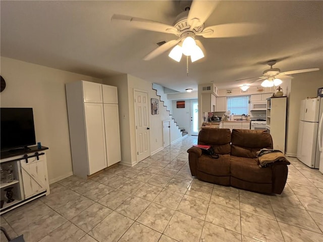 living room with ceiling fan and light tile patterned floors