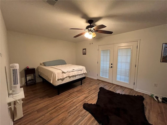 bedroom featuring dark hardwood / wood-style flooring, french doors, and ceiling fan