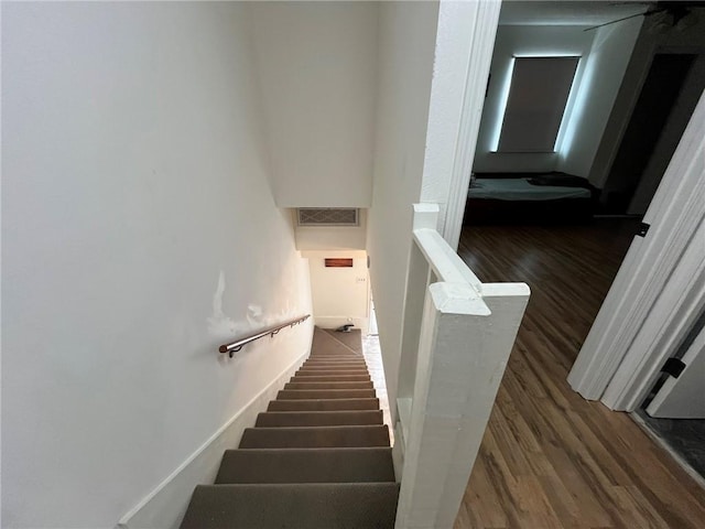 staircase featuring wood-type flooring