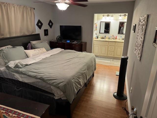 bedroom with ceiling fan, light hardwood / wood-style floors, and connected bathroom