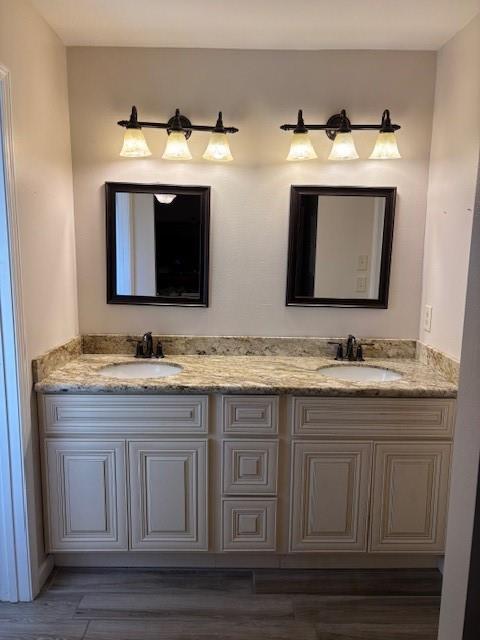 bathroom with hardwood / wood-style floors and vanity