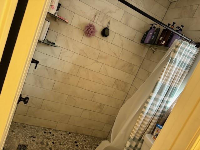 bathroom with a shower with shower curtain