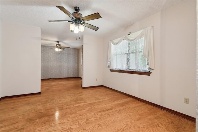 spare room with light hardwood / wood-style flooring and ceiling fan