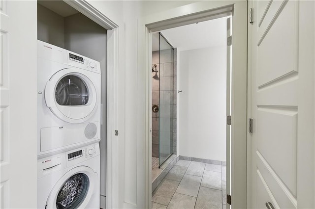 washroom with stacked washer / dryer and light tile patterned floors