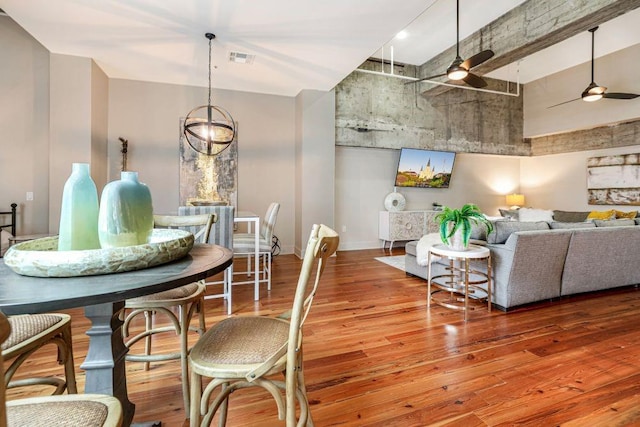 dining room with ceiling fan and hardwood / wood-style flooring