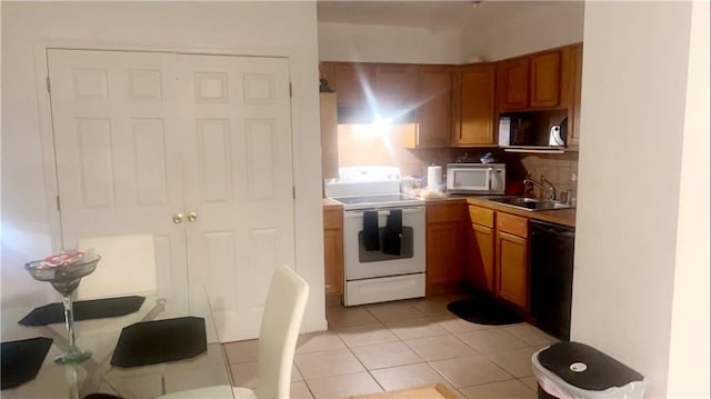 kitchen featuring dishwasher, sink, white electric stove, backsplash, and light tile patterned flooring