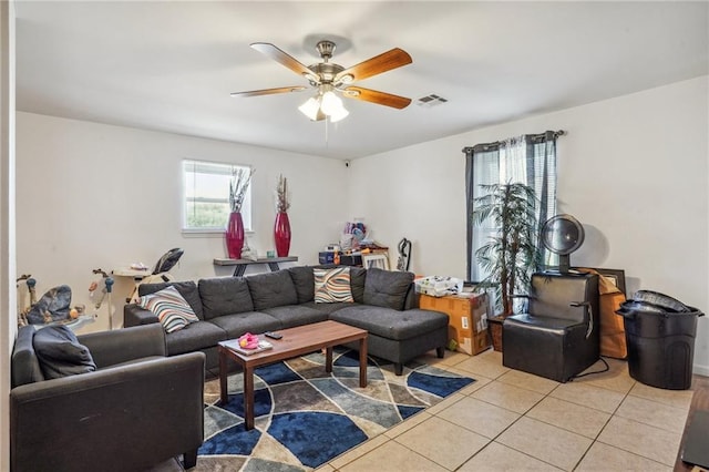 living room with ceiling fan, light tile patterned floors, and a healthy amount of sunlight