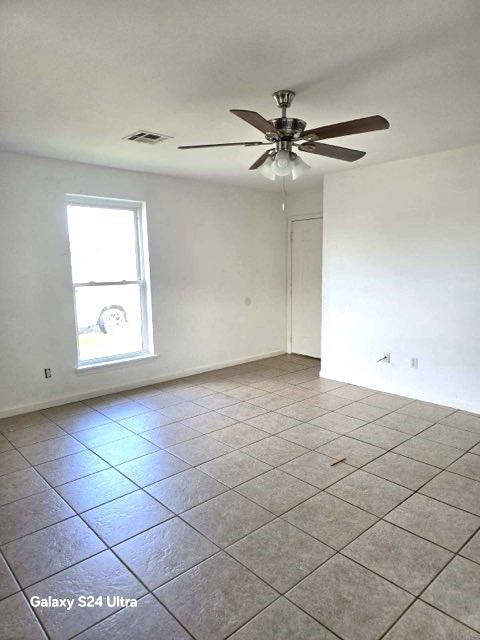 unfurnished room featuring ceiling fan and light tile patterned flooring