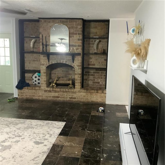 living room with a brick fireplace and a textured ceiling