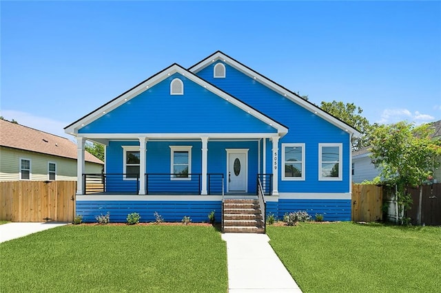 bungalow featuring a porch and a front lawn