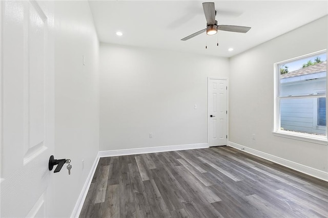 spare room with hardwood / wood-style floors, ceiling fan, and a healthy amount of sunlight