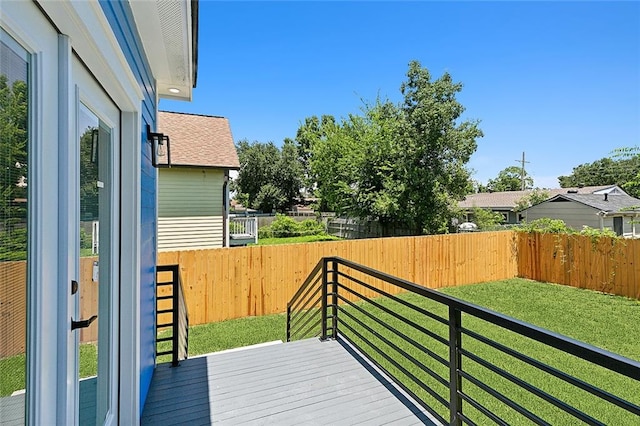 wooden terrace with a lawn