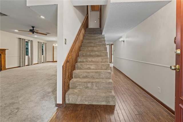 stairway featuring hardwood / wood-style flooring and ceiling fan