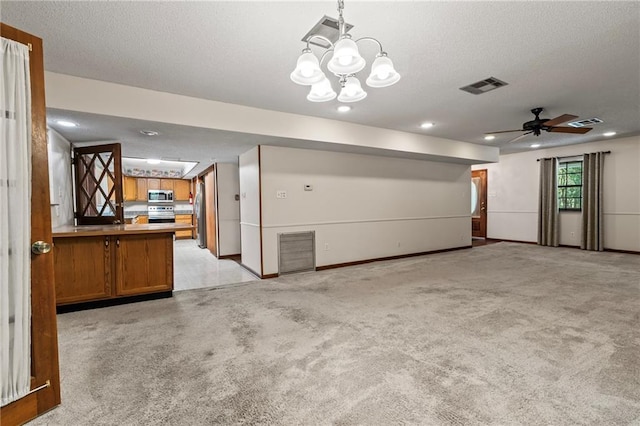 interior space featuring light carpet, ceiling fan with notable chandelier, and a textured ceiling