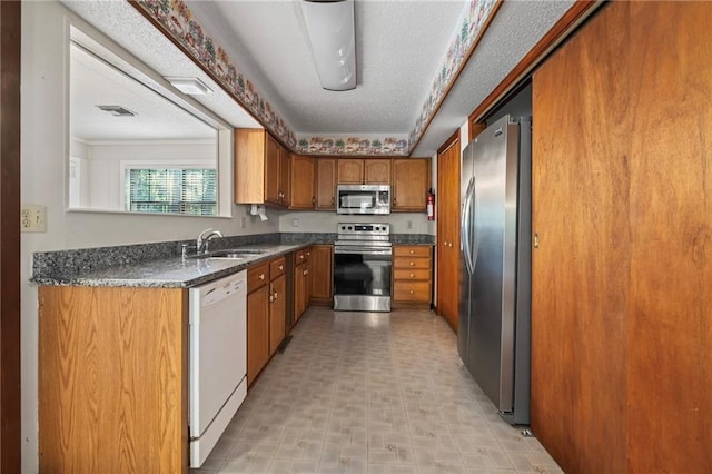 kitchen featuring light tile patterned flooring, stainless steel appliances, and sink