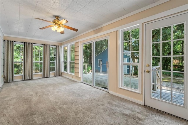 unfurnished sunroom featuring ceiling fan