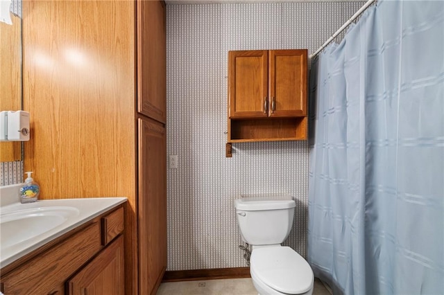 bathroom with vanity, toilet, and tile patterned flooring